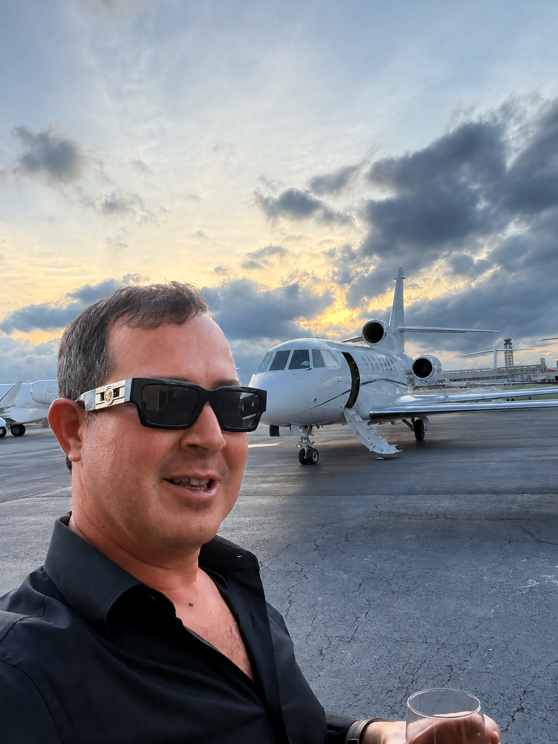 Greg Mirmelli beside a private jet